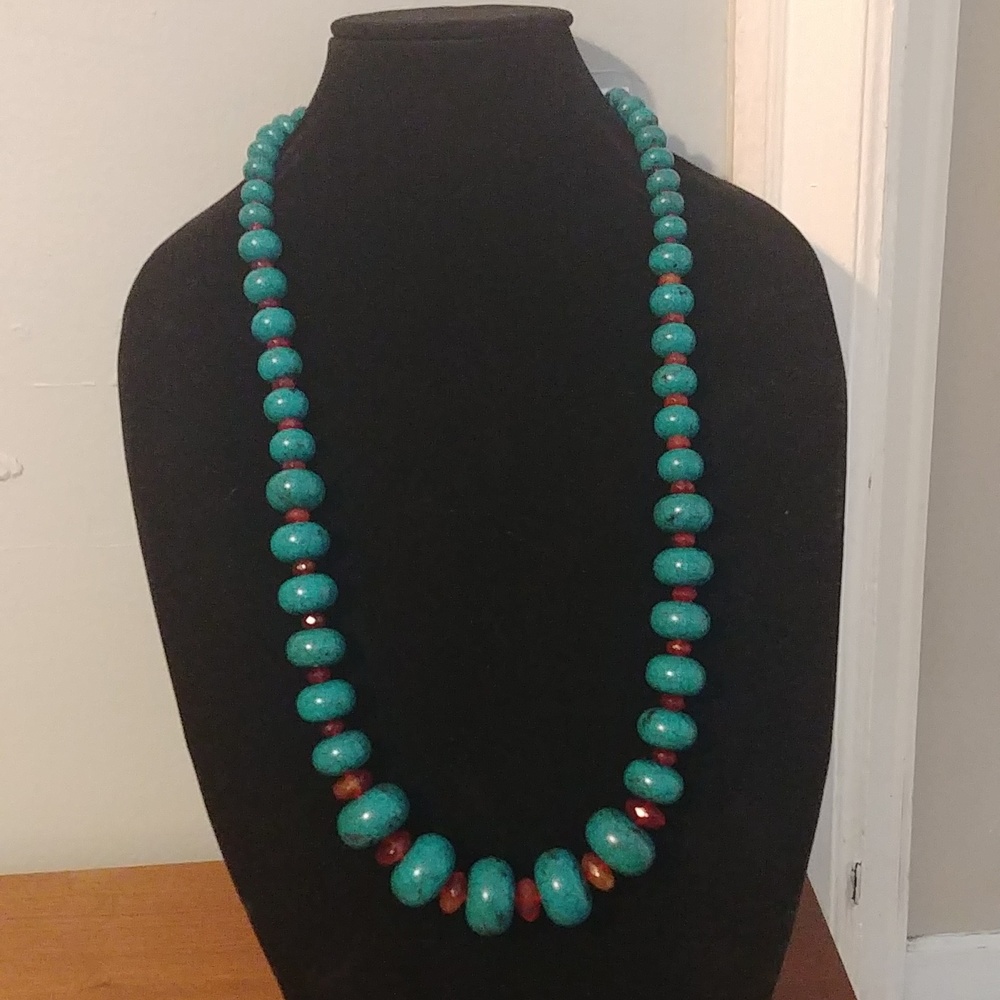 Turquoise and amber colored beaded 26 inches in length necklace.